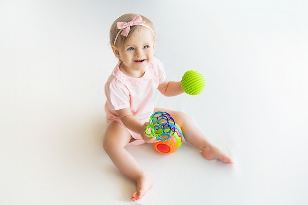 Happy Nursery Baby Girl Playing With Colorful Rubber Ball Home 215497 318